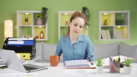 Unhappy-young-business-woman-working-in-her-home-office.